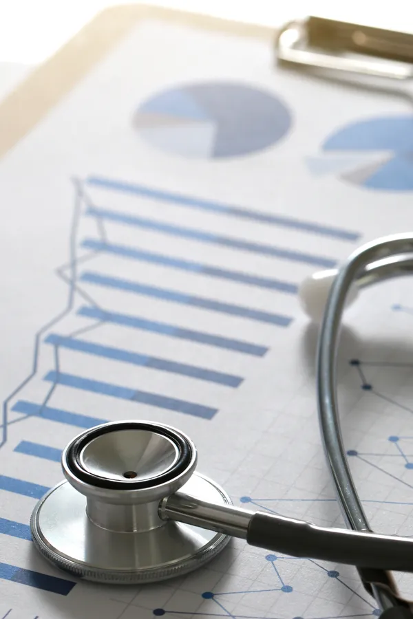 Annual exam test results on a desk with a stethoscope. Get an annual wellness exam from Guerda Johnson, FNP-C in Tyler East Texas Area.