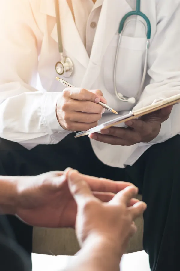 DOT-Physical-Exam-Treatment A clinician talks a patient through exam results. Get DOT physical exams from Guerda Johnson, FNP-C in Tyler East Texas Area.