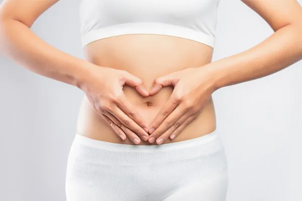 Gut-Repair-Peptides-Clinic A woman holds her hands over her belly in a heart shape. Get Gut Repair Peptides treatment from Guerda Johnson, FNP-C in Tyler East Texas Area.