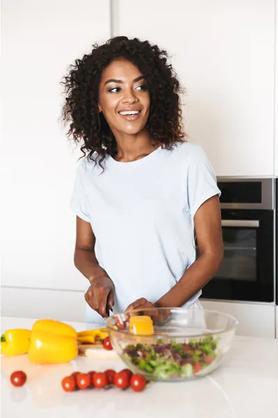 Gut-Repair-Peptides-Treatment A woman prepares a healthy salad. Get Gut Repair Peptides treatment from Guerda Johnson, FNP-C in Tyler East Texas Area.