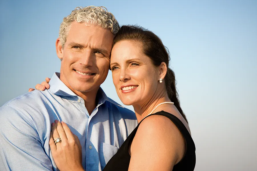 Healthy-Aging-Peptides-Doctor A middle-aged caucasian couple embraces in the sunshine, happy with the healthy aging peptide treatments from Guerda Johnson, FNP-C in Tyler East Texas Area