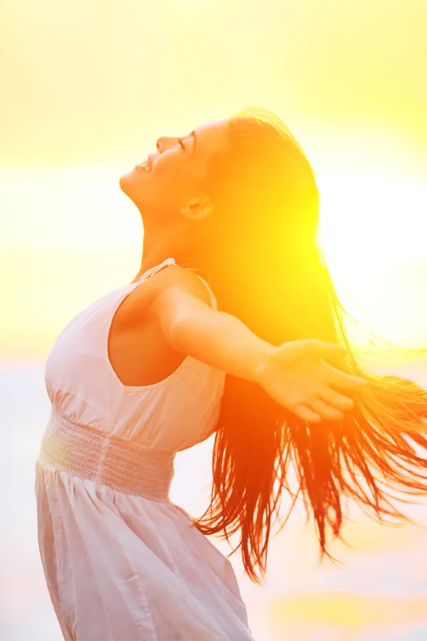 Hydration-IV-Therapy-Treatment A woman opens her arms to the sky at sunrise. Get Hydration IV Therapy from Guerda Johnson, FNP-C in Tyler East Texas Area.
