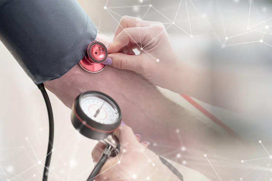 Hypertension-Clinic A man gets his blood pressure taken. Schedule hypertension treatment from Guerda Johnson, FNP-C in Tyler East Texas Area.