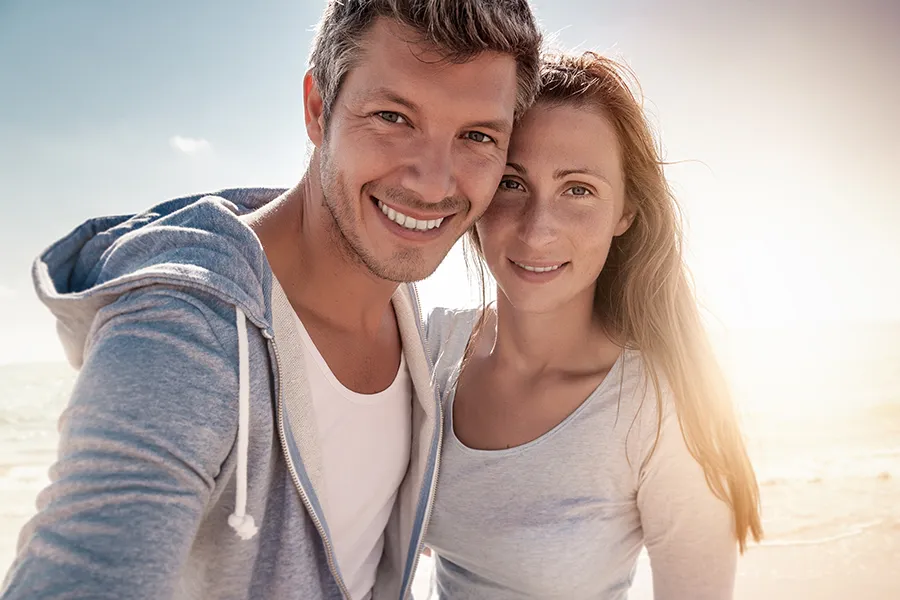 IV-Therapy-for-Skin-Health-Clinic A middle-aged couple with youthful skin at the beach. Get IV Therapy for skin health from Guerda Johnson, FNP-C in Tyler East Texas Area.