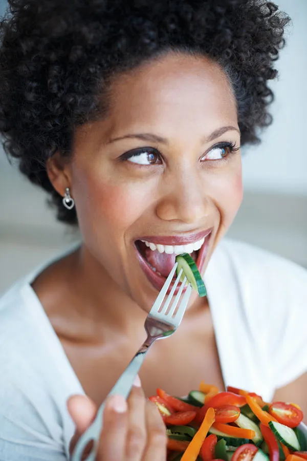 Lipo-Mino-Vitamin-Shot-Treatment A happy black woman eating a healthy salad. Get Lipo-Mino vitamin shots for weight loss from Guerda Johnson, FNP-C in Tyler East Texas Area.