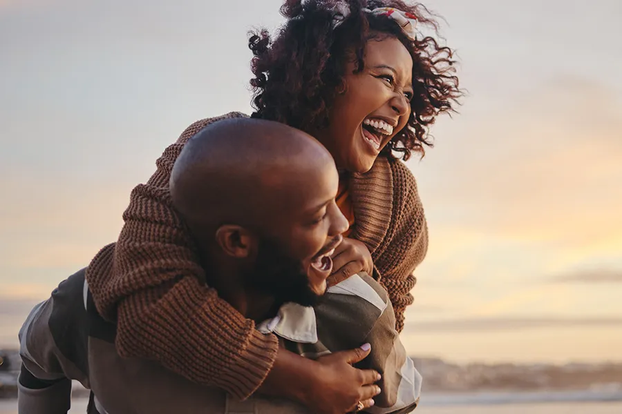 Low-Libido-Clinic A happy black couple embrace at sunset. Get treatment for low libido from Guerda Johnson, FNP-C in Tyler East Texas Area.