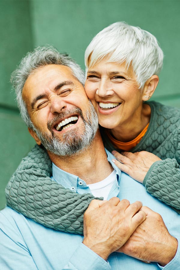 Membership-Programs-Treatment A mature couple embracing and smiling. Learn about Guerda Johnson, FNP-C in Tyler East Texas Area's membership programs.