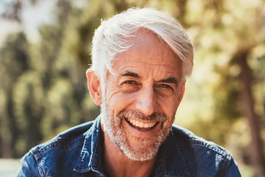 Mens-Health-Clinic A handsome mature man smiling in the forest. Make an appointment with men's health expert Guerda Johnson, FNP-C in Tyler East Texas Area today.