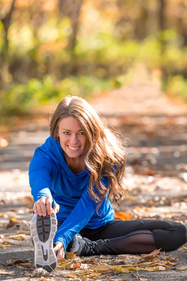Performance-Recovery-IV-Therapy-Treatment A woman stretches before a trail run. Get IV Therapy for performance recovery relief from Guerda Johnson, FNP-C in Tyler East Texas Area.