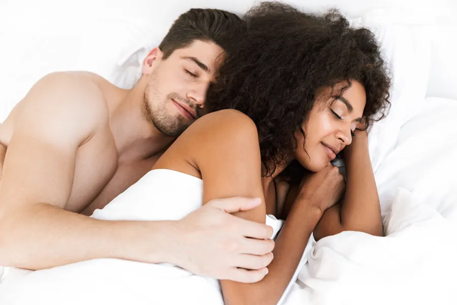 STD-Testing-Clinic A white man and black woman in bed. Get STD testing from Guerda Johnson, FNP-C in Tyler East Texas Area.