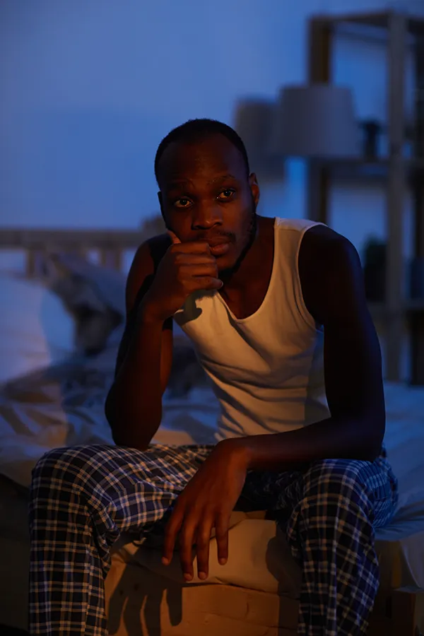 Mood-Imbalance-Clinic A black woman feeling stress bites her nails and looks withdrawn. Get treatment for mood imbalances and stress from Guerda Johnson, FNP-C in Tyler East Texas Area.