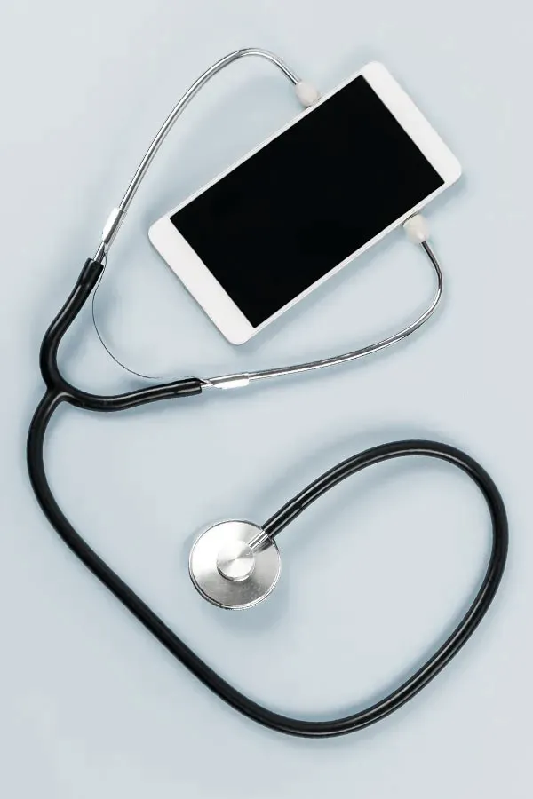 Telemedicine-Treatment A smartphone with a stethoscope attached to it, symbolizing Telemedicine treatment from Guerda Johnson, FNP-C in Tyler East Texas Area.